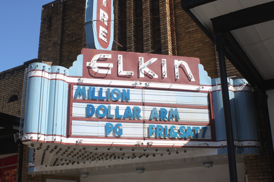 Elkin 'Million Dollar Arm PG Frissat 7' red and blue movie sign.